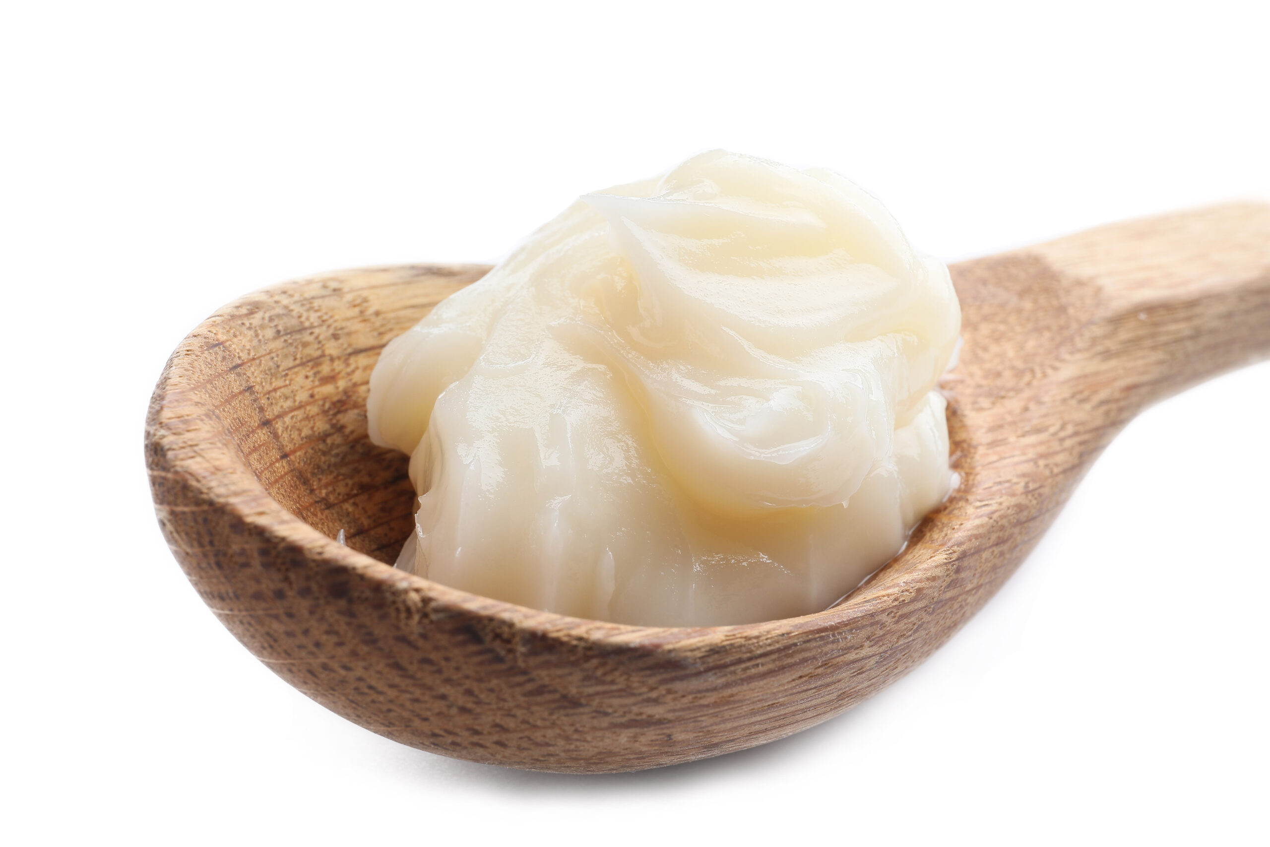 Spoon with beef tallow on white background